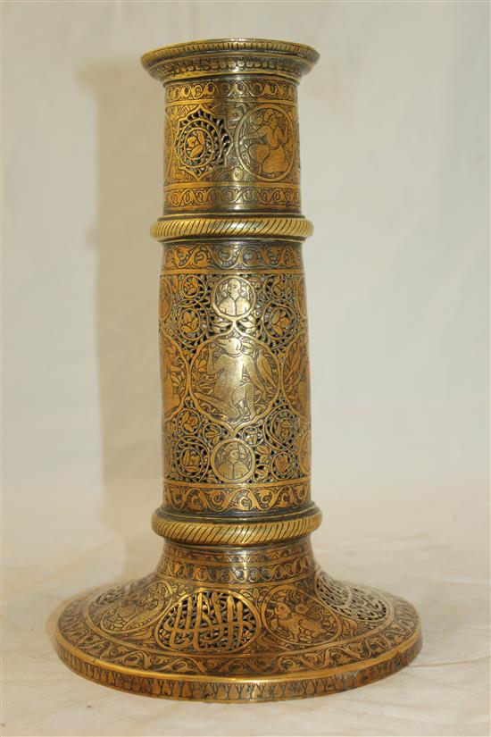 A 19th century Qajar Islamic pierced brass torch stand, 10.5in.